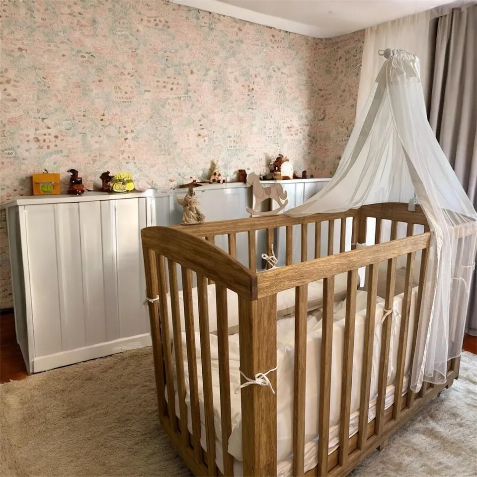 Natural Limba wood baby crib, showcasing its warm texture and modern design. - 1