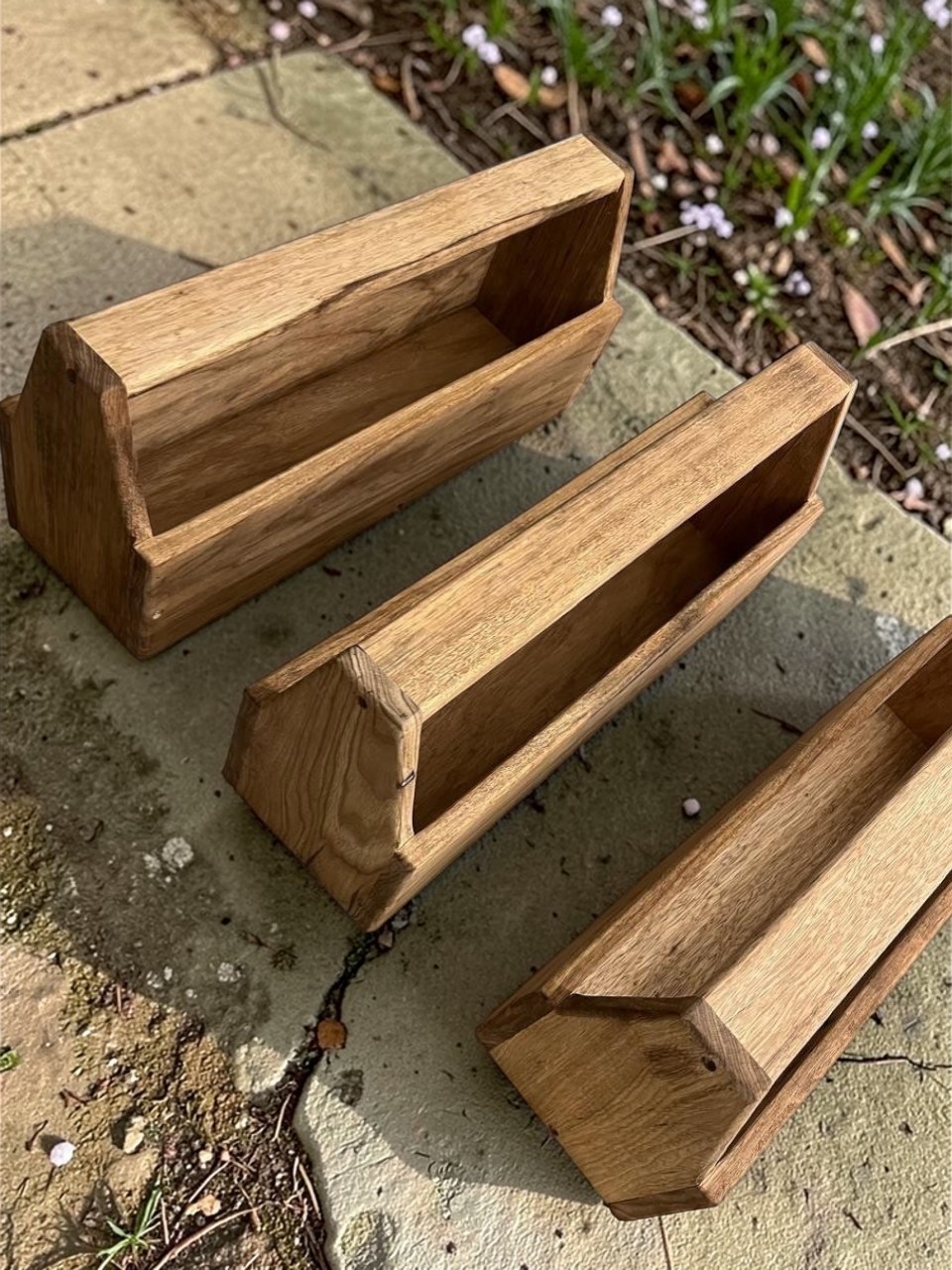 Wooden chicken feeder with chickens in a real farm setting - 1